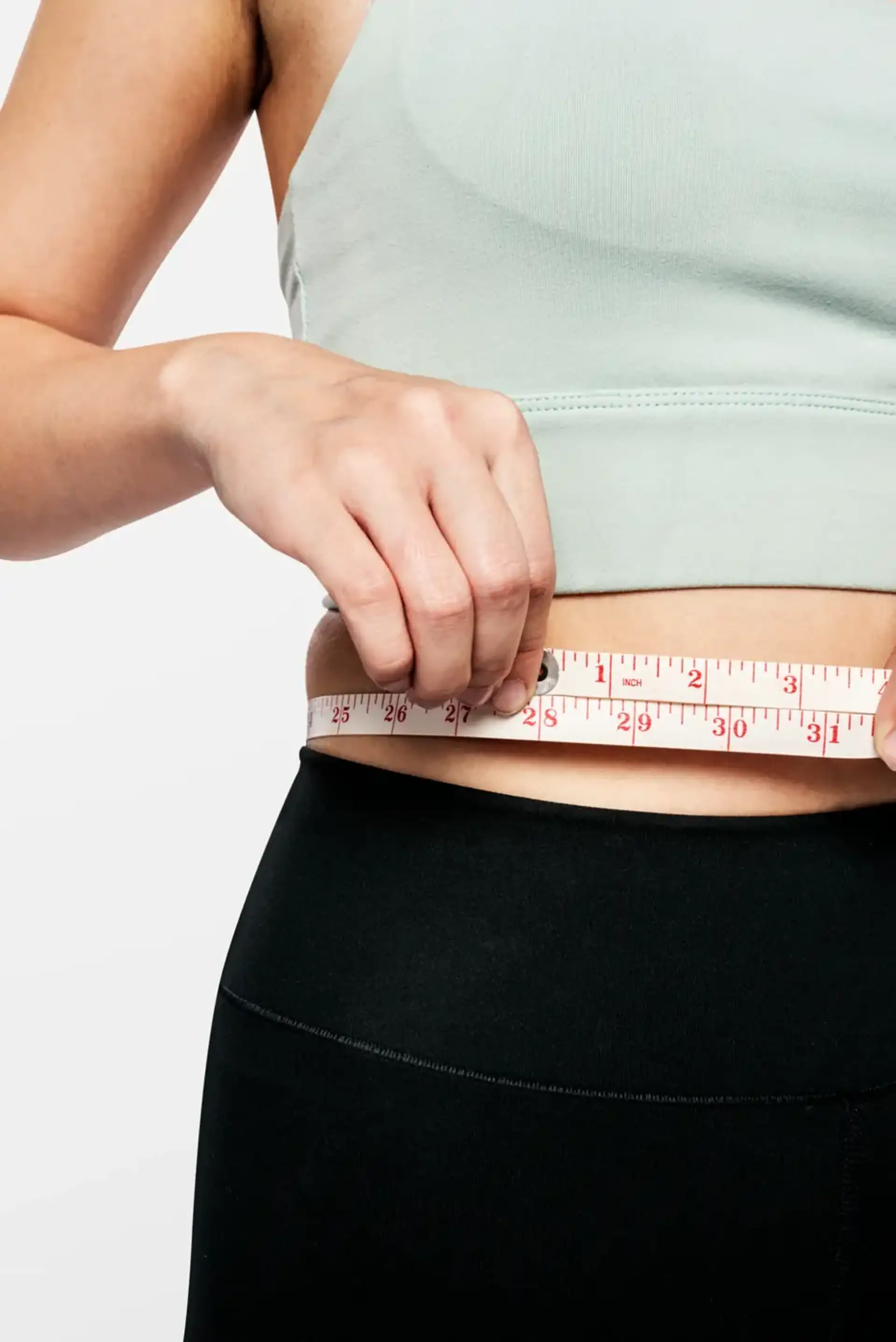 active-woman-measuring-her-waist